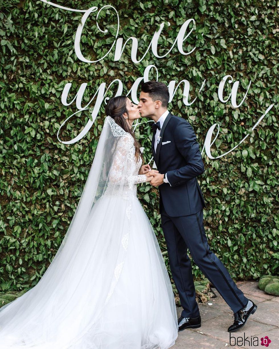 Marc Bartra y Melissa Jiménez besándose frente a un cartel de 'Once upon a time'