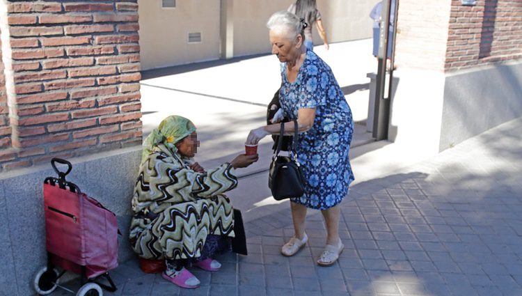 La madre de Antonio Carmona da limosna a una mujer tras visitar a su hijo en el hospital