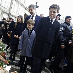 Los hijos, las nueras y los nietos de Enrique de Dinamarca miran los recuerdos colocados en su honor en Amalienborg