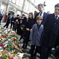 Los hijos, las nueras y los nietos de Enrique de Dinamarca miran los recuerdos colocados en su honor en Amalienborg