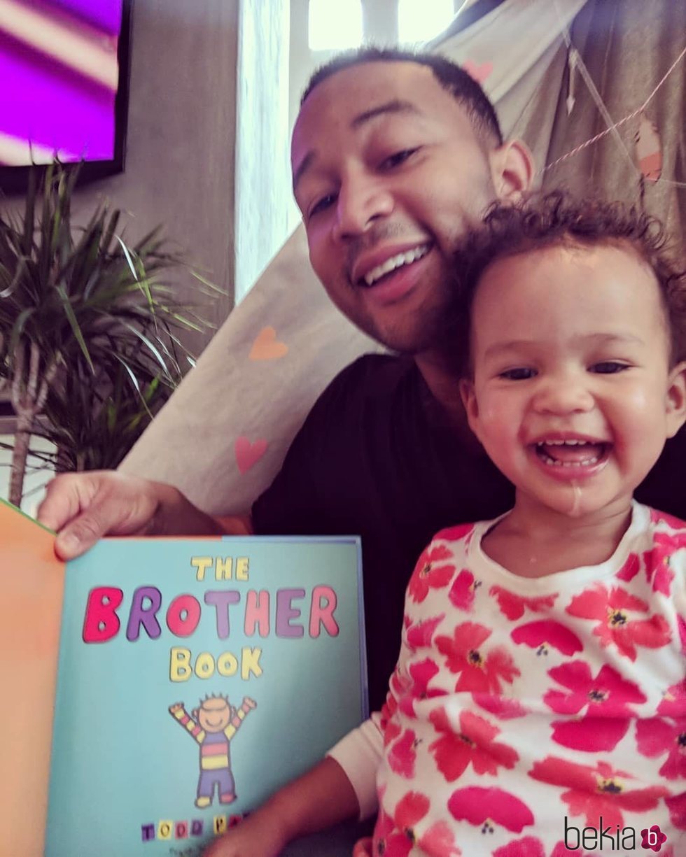 John Legend junto a su hija Luna leyendo un libro