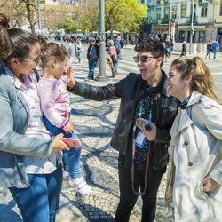 Alfred y Amaia saludan sonrientes a una niña en Lisboa antes de Eurovisión 2018