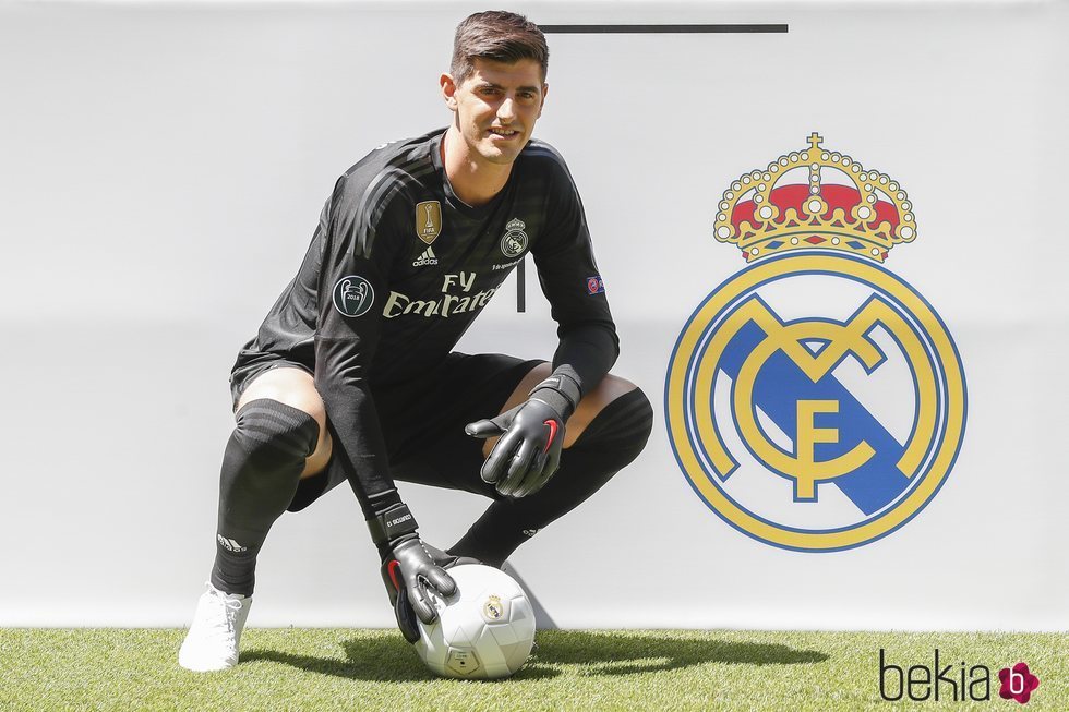 Thibaut Courtois posando con la equipación del Real Madrid