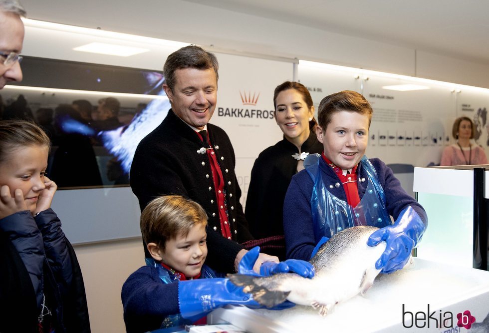 Christian y Vicente de Dinamarca con un salmón junto a Federico, Mary e Isabel de Dinamarca