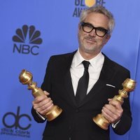 Alfonso Cuarón con sus dos premios en los Globos de Oro 2019