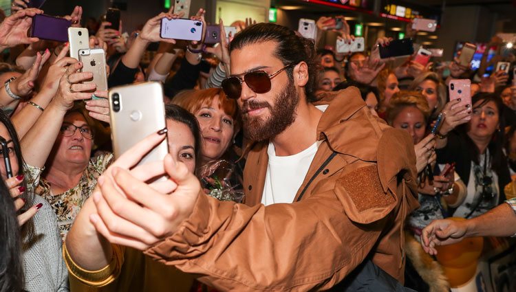 Can Yaman haciéndose una foto con una fan a su llegada a España