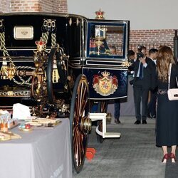 Rania de Jordania y la Reina Letizia ante un carruaje en las Escuelas Taller de Patrimonio Nacional