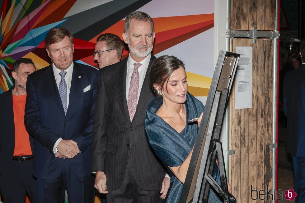 La Reina Letizia firma en una obra en su visita al Museo Straat en Ámsterdam