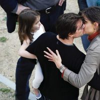 Tom Cruise besa a Katie Holmes mientras sostiene a su hija Suri en brazos