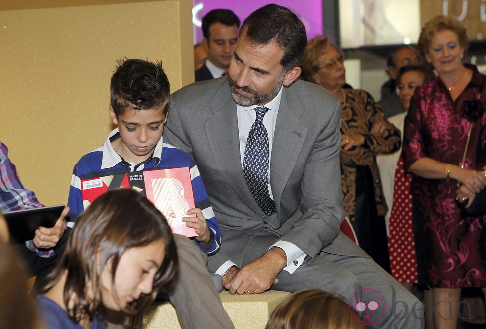 El Príncipe Felipe con unos niños durante la inauguración de la Casa del Lector