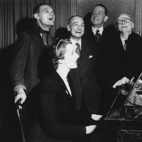 Margaret Thatcher al piano junto a cuatro votantes