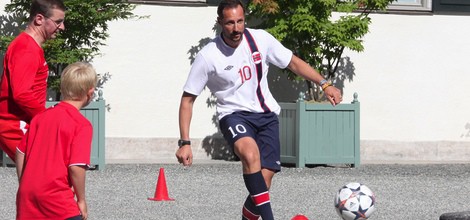 Haakon de Noruega jugando al fútbol en un partido amistoso