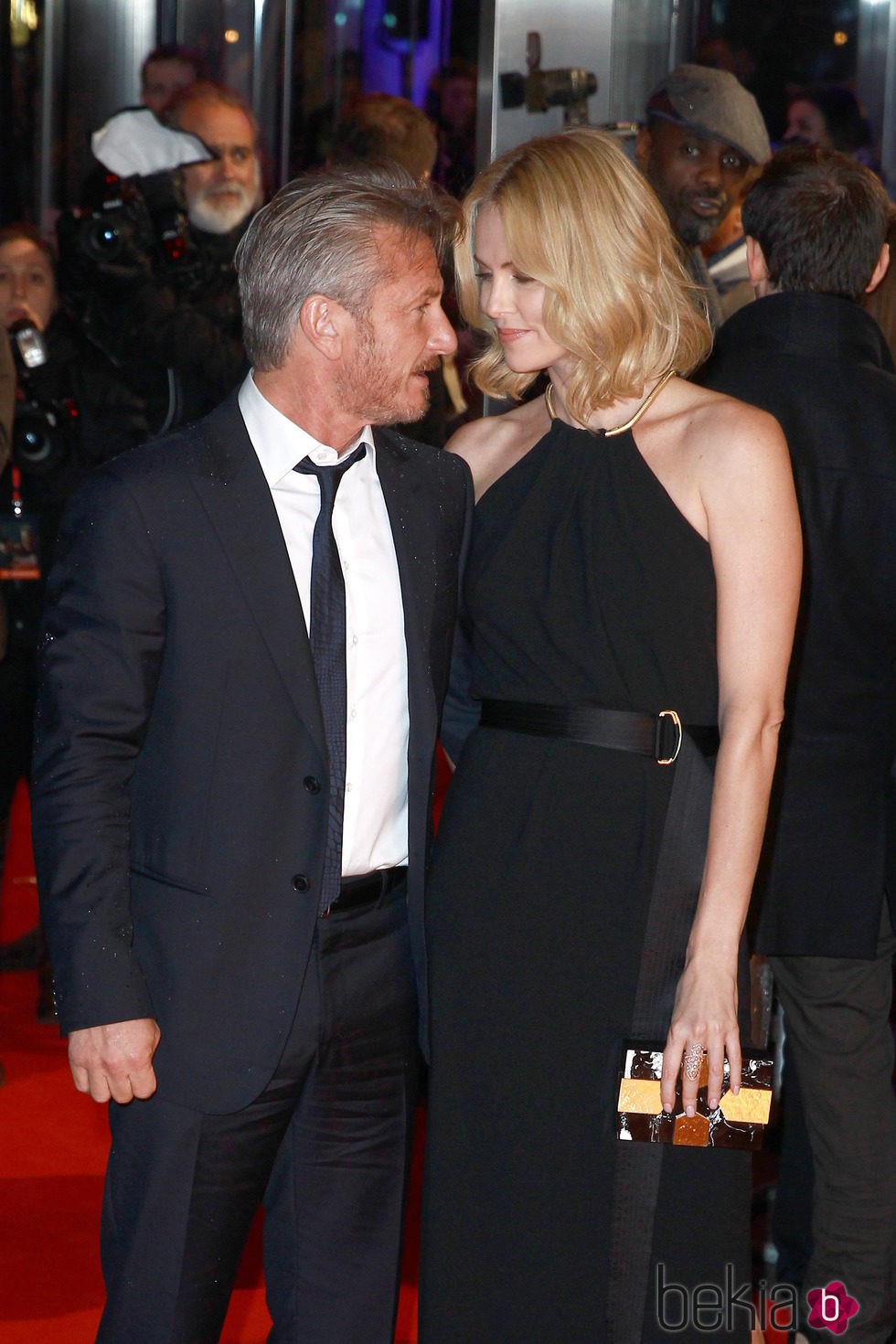 Sean Penn y Charlize Theron mirándose de forma cómplice en el estreno de 'The Gunman'