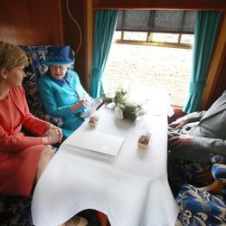 La Reina Isabel y el Duque de Edimburgo con la Primera Ministra de Escocia en un tren