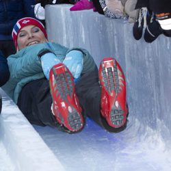 Mette-Marit de Noruega tirándose por un tobogán en las celebraciones del 25 aniversario del reinado de Harald de Noruega