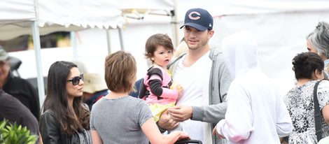 Mila Kunis, Ashton Kutcher y su hija Wyatt charlando con unos conocidos